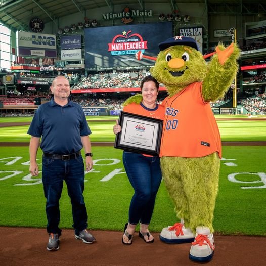 Astros mascot Orbit salutes Stacey Vanhorn, a Cinco Ranch Junior High School teacher of the month.